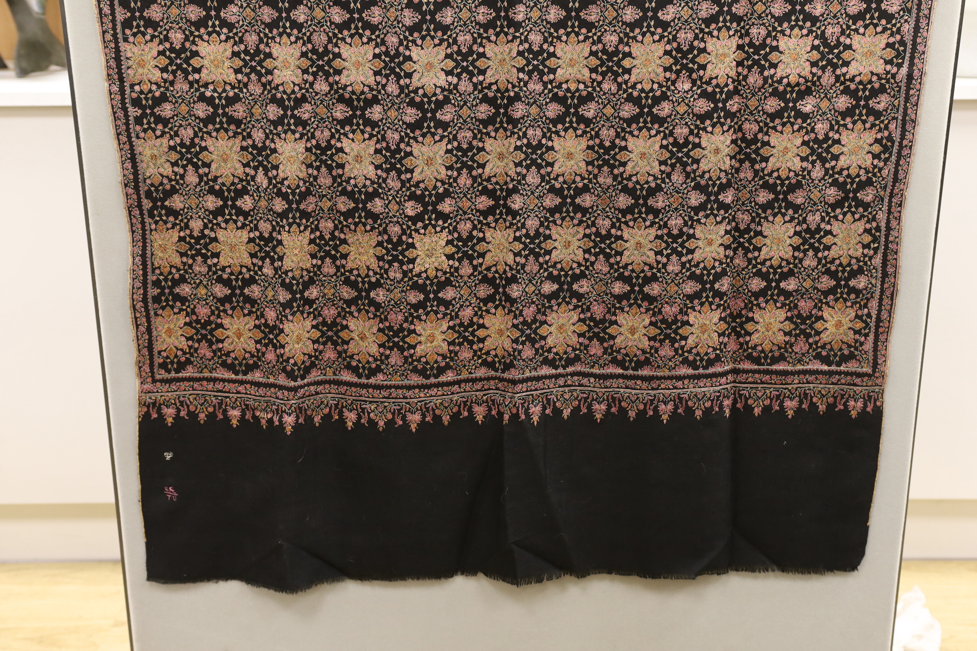 A very finely hand embroidered multicoloured silk black cashmere stole, with embroidered signature and number, 198cm long x 95cm wide